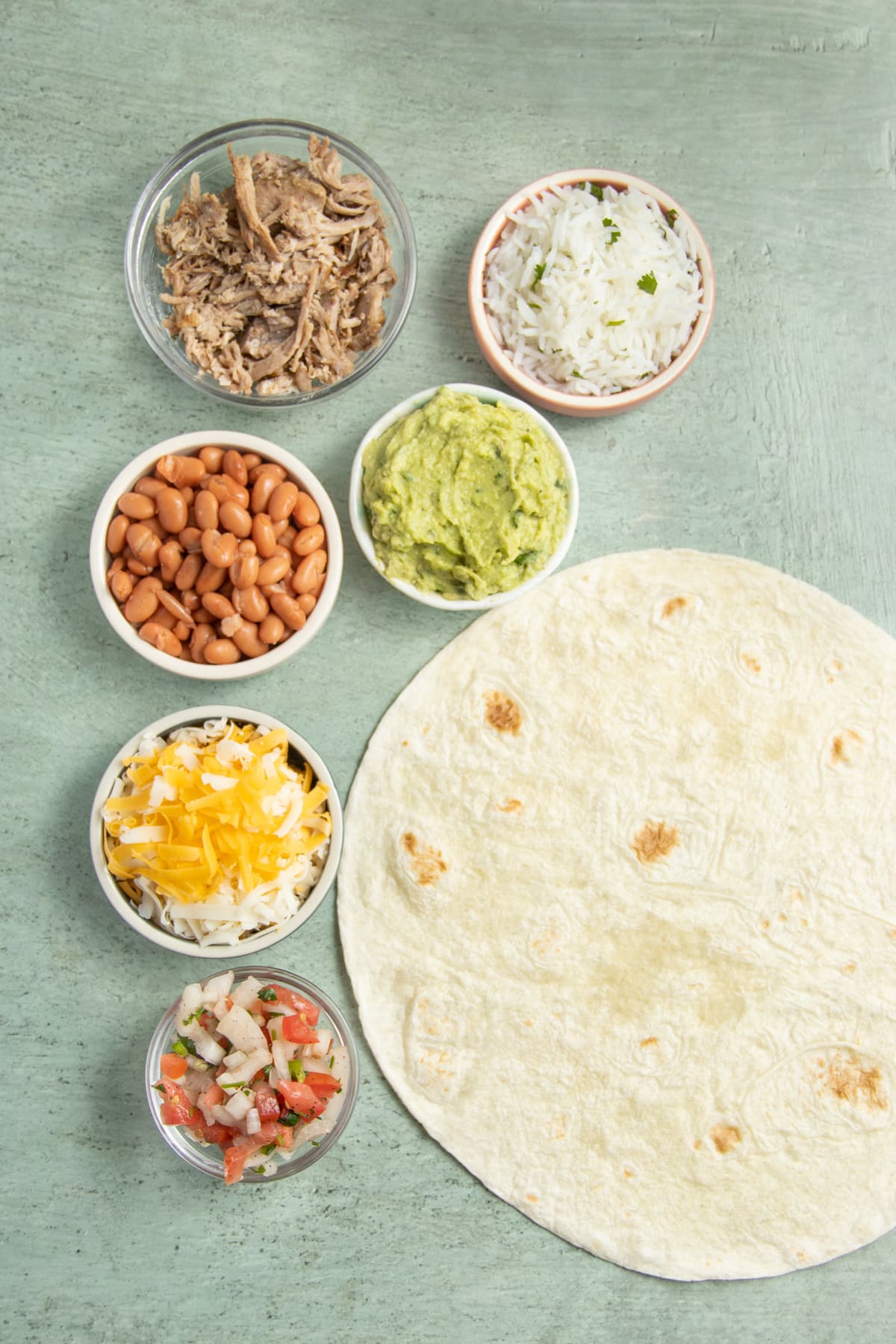 This is a picture the ingredients needed to make carnitas burritos.