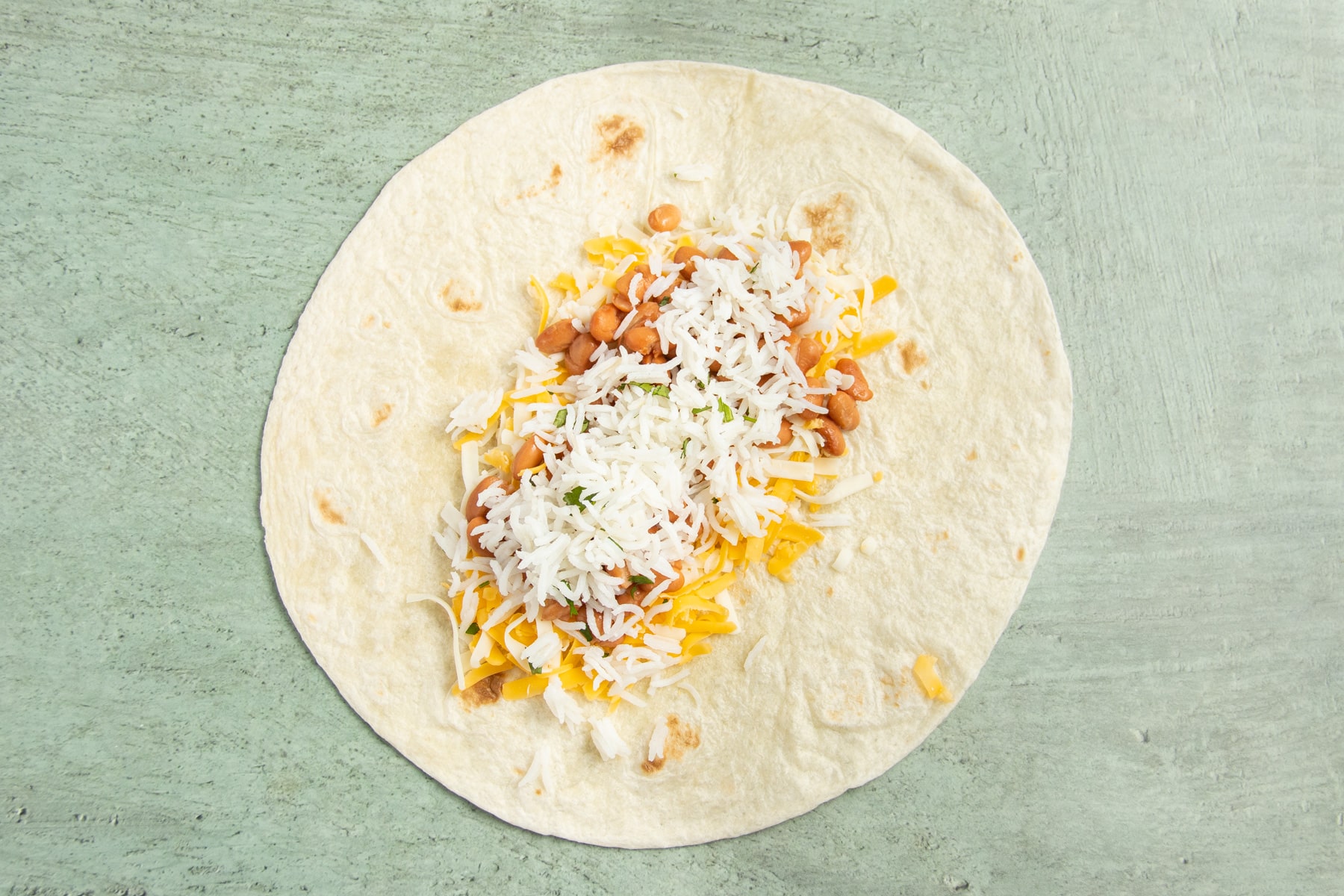 This is a picture of a large tortilla with cheese added.
