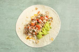 This is a picture of a large tortilla with guacamole added.