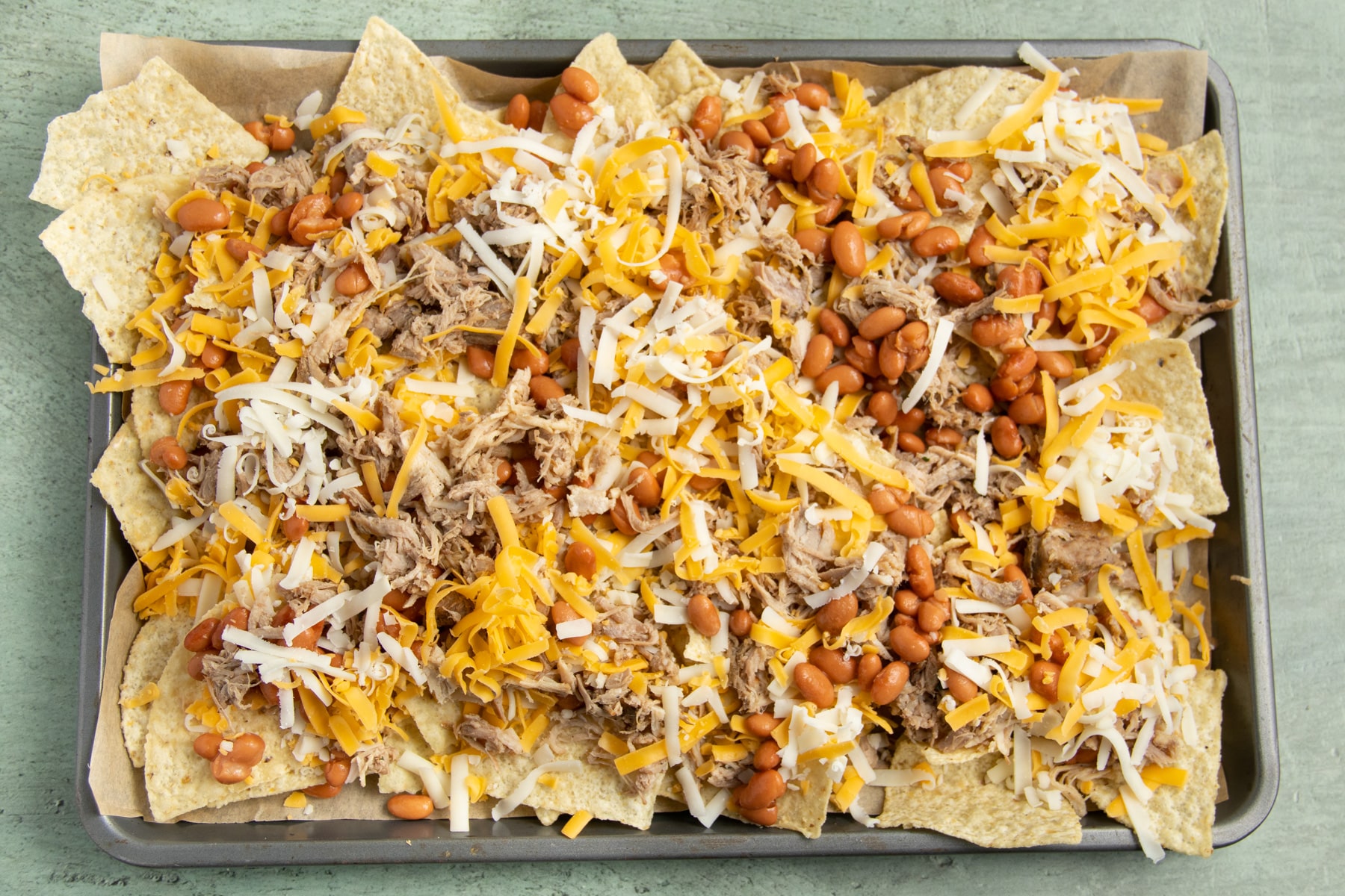 This is a picture of the carnitas nachos before baking.