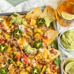 This is a square photo of carnitas nachos.