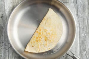This is a picture of the carnitas quesadilla cooked in a skillet.