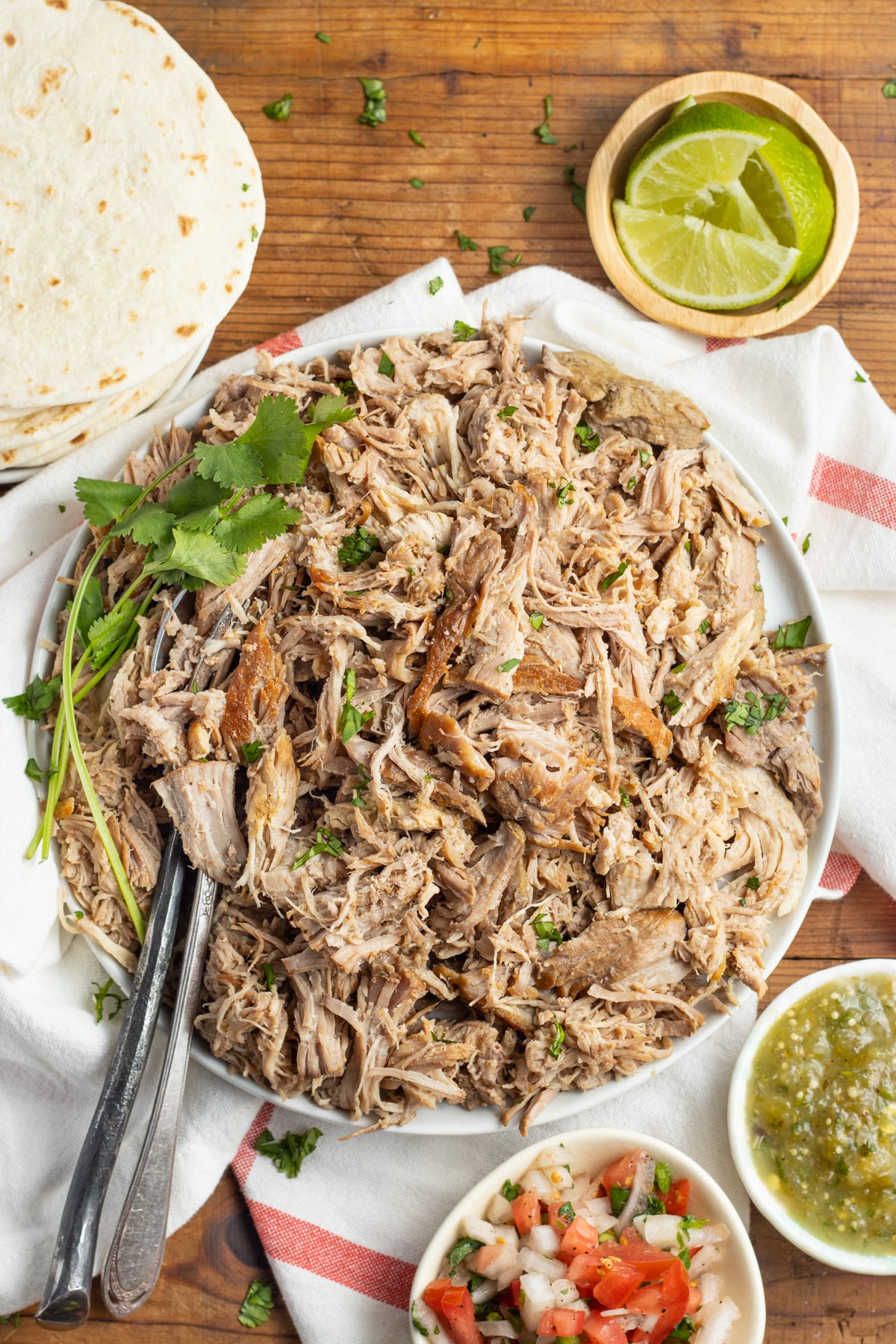 This is a picture of shredded slow cooker pork carnitas in a large plate.