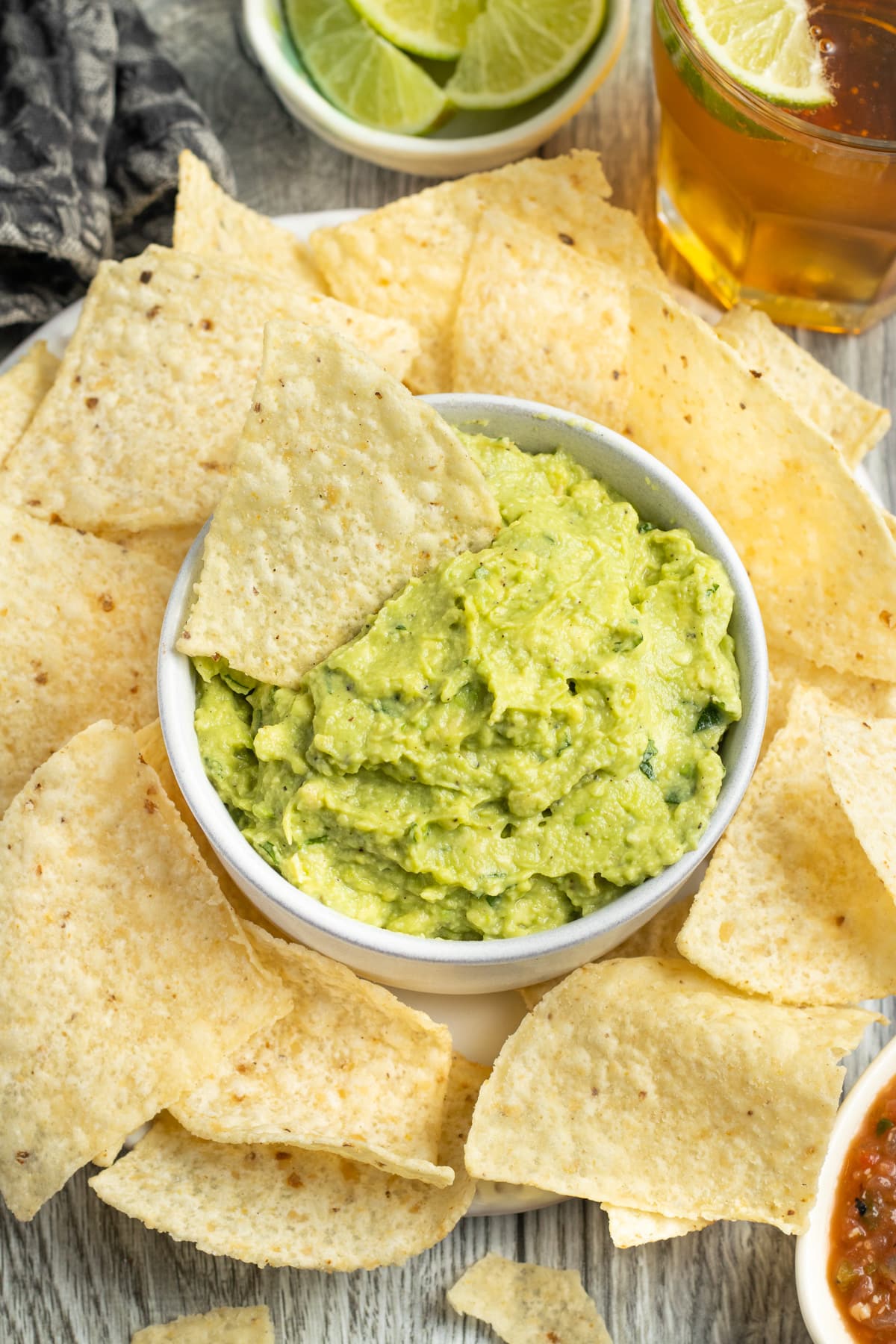 This is a picture of a bowl of easy guacamole with tortilla chips.