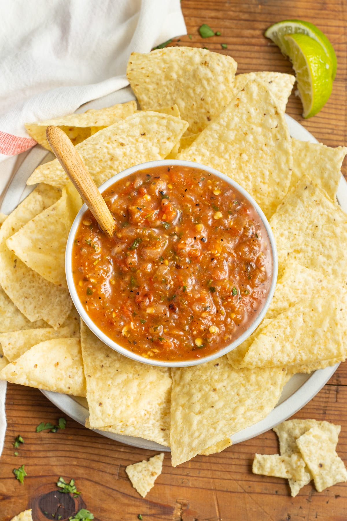 This is a picture of a bowl of roasted red salsa with chips.