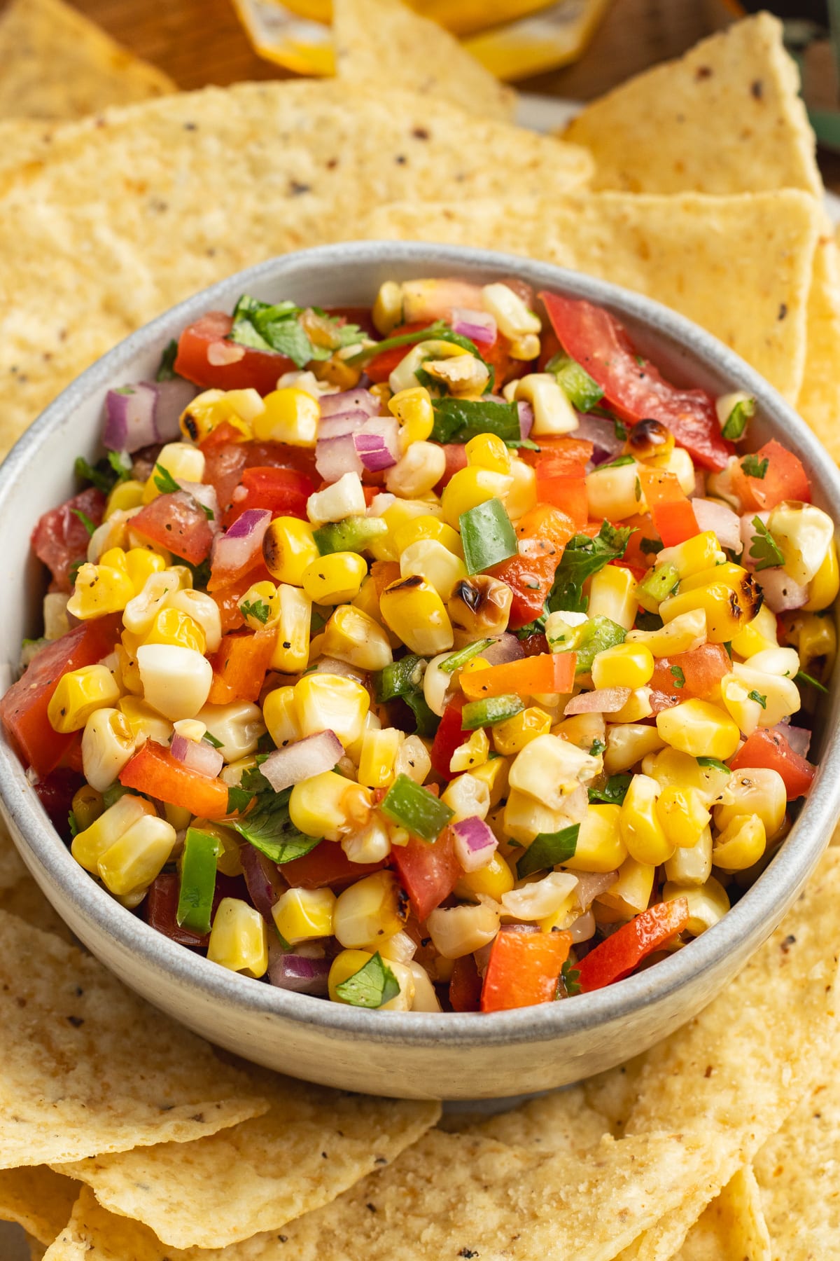 This a picture of a bowl of corn pico de Gallo.