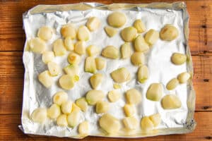 This is a picture of garlic cloves on a baking sheet.