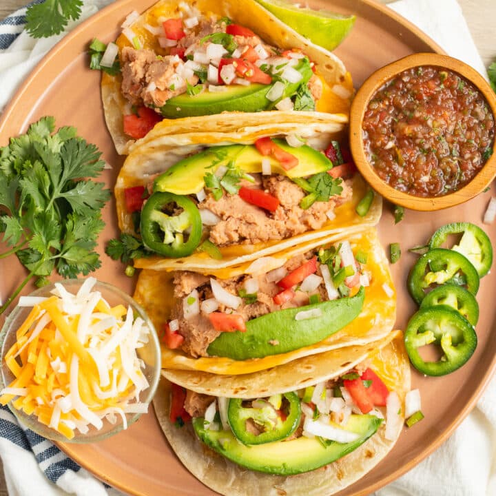 This is a picture of a plate of bean and cheese tacos.