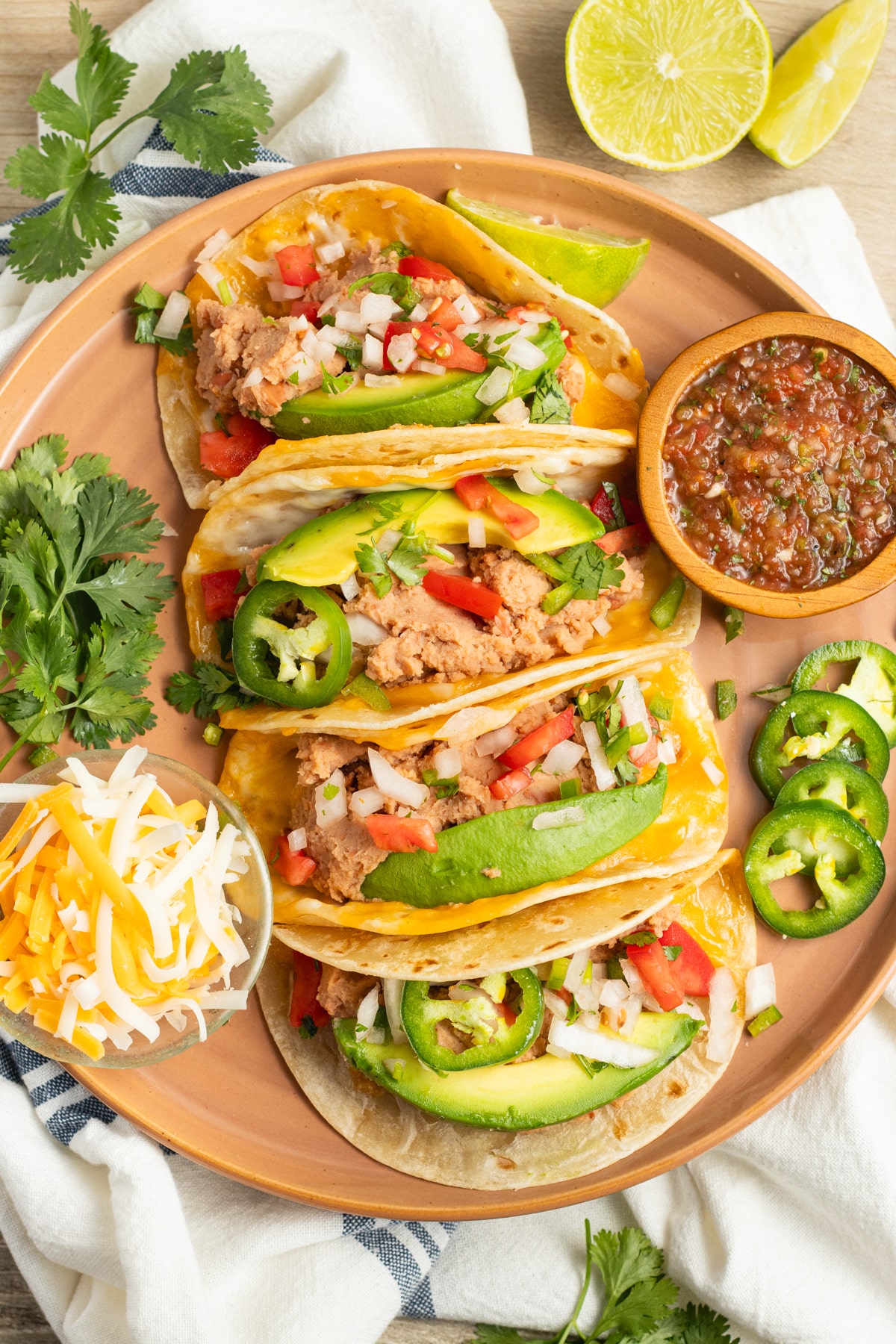 This is a picture of a plate of bean and cheese tacos.