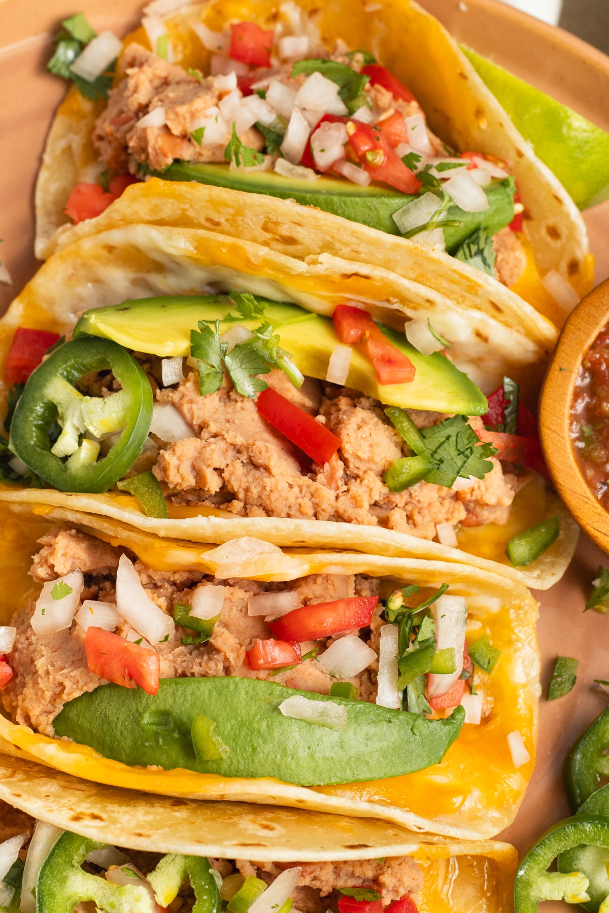 This is a picture of a plate of bean and cheese tacos.