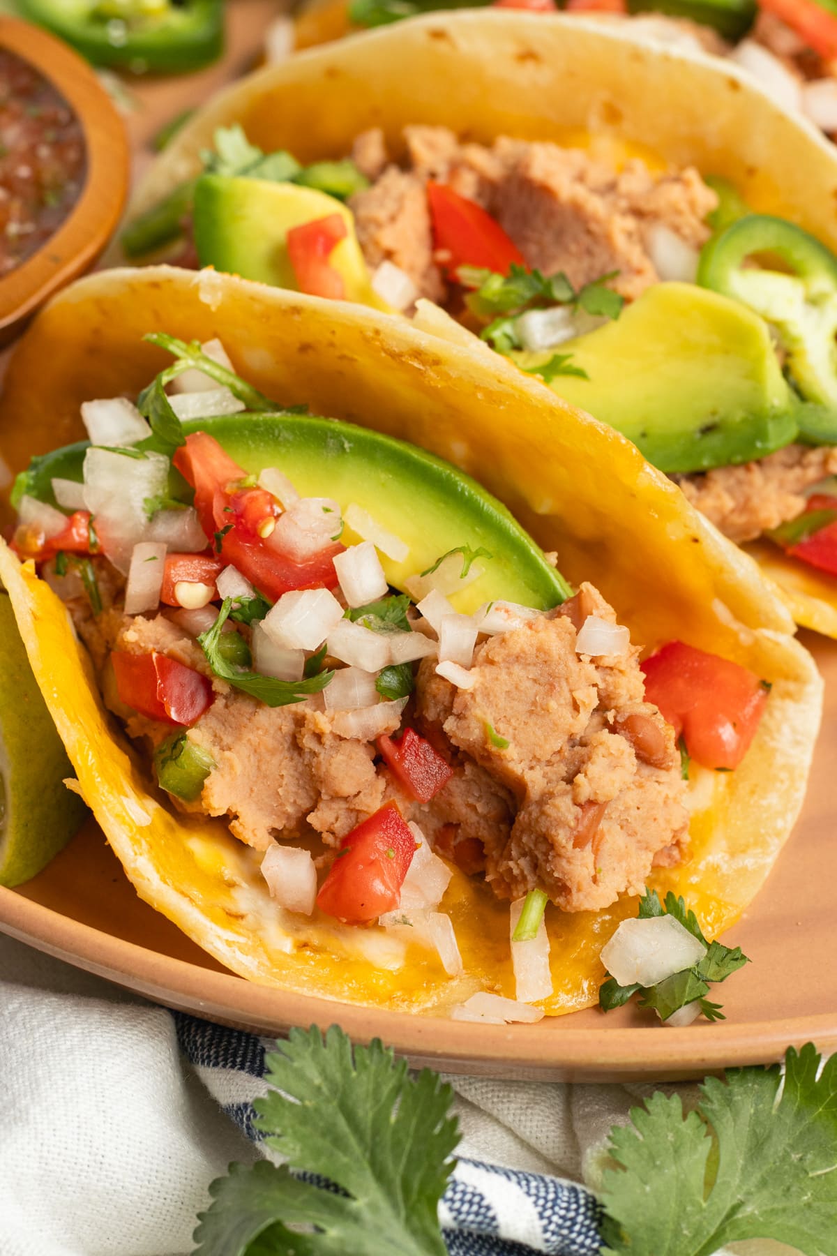 This is a picture of a plate of bean and cheese tacos.