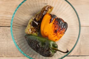 This is a picture of the peppers in bowl after being roasted.